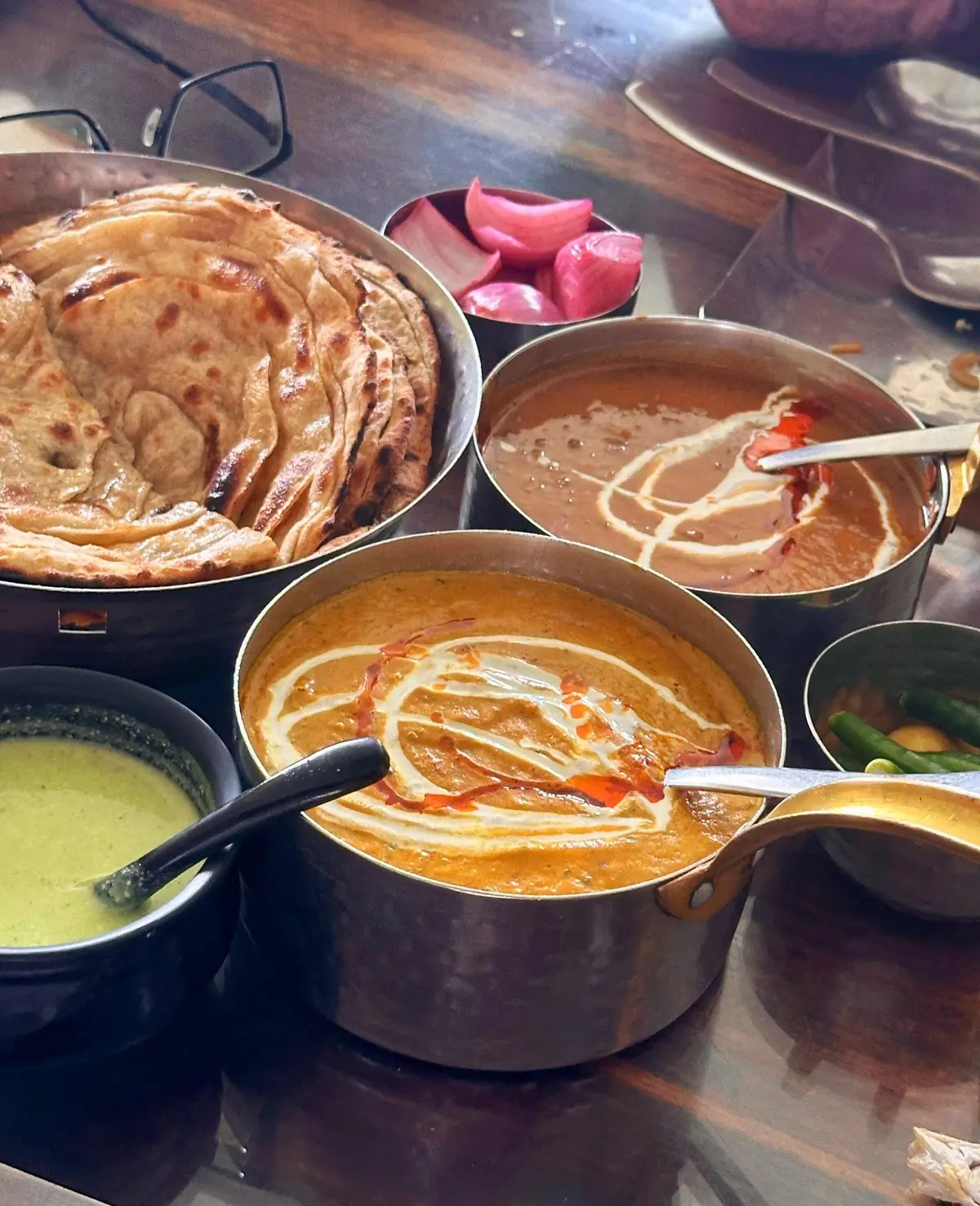 Lachha parathas, dal makhani and paneer makhani on the table at Uss da Dhaba, Dehradun