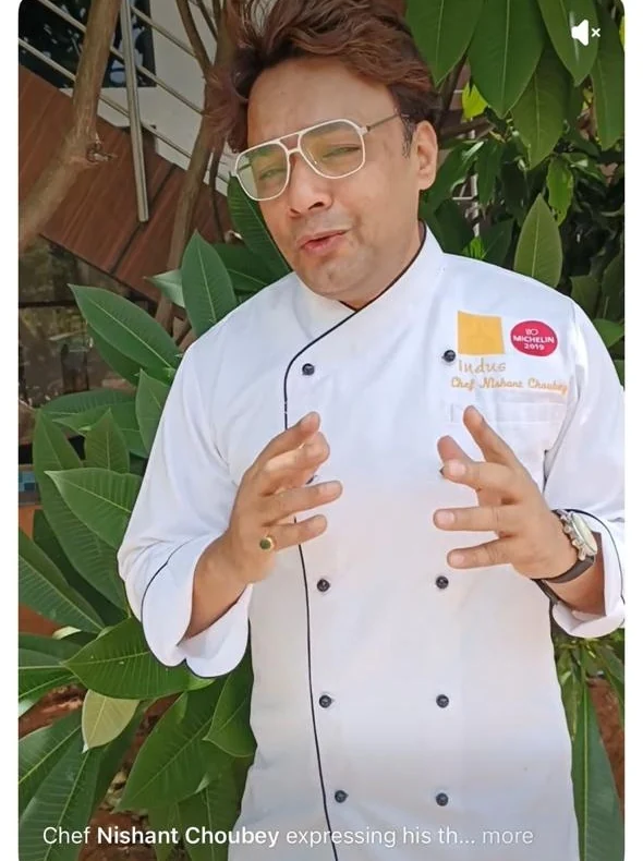 Chef Nishant Choubey in chef whites recording a video message for the Delhi Foodiez group