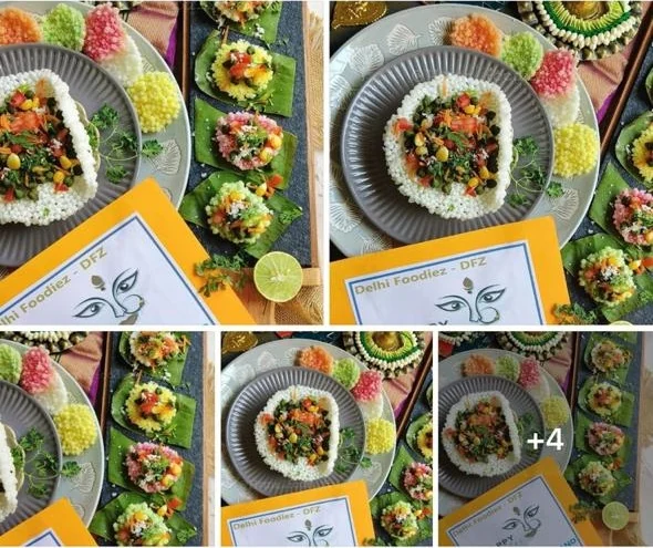 A finale entry plated on a banana leaf with rice, vegetables and edible flower garnishes